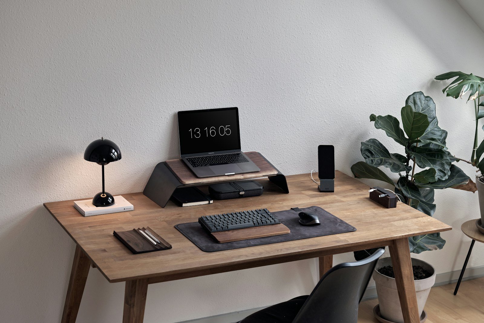 Professional workspace with a laptop on a wooden desk.
